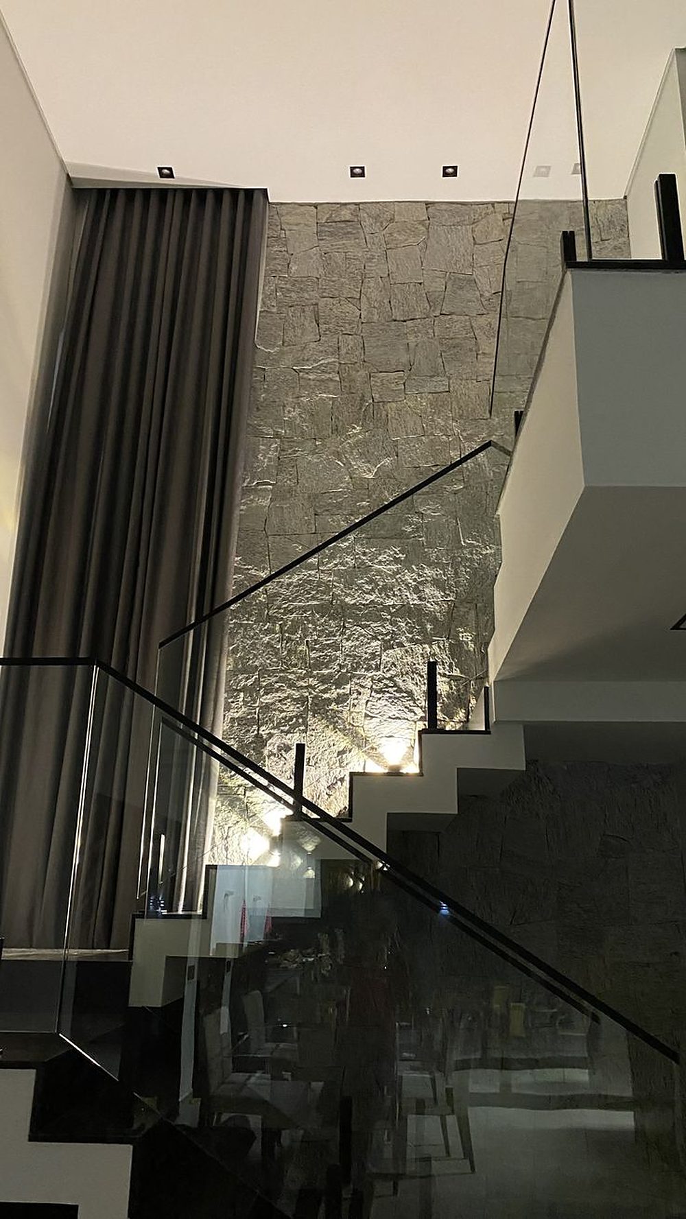 Modern staircase and stone accent wall renovation by Summit Home Renovation, Washington